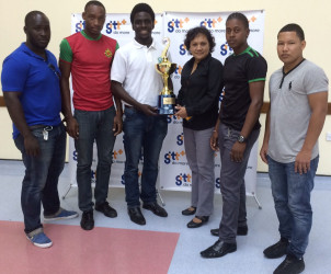 Second VP of the GRFU, Joshua Griffith pose with the GTT 10s championship trophy in the presence of the captains of The Pepsi Hornets, GDF, UG Wolves and the GPF. 