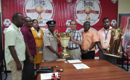 President of the GFA, Clifton Hickens (fourth from right) collecting the championship trophy from Banks Beer Brand Manager Brian Choo-Hen following the conclusion of the launch ceremony while other members of the GFA and Banks DIH Limited look on.
 