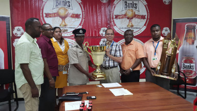 President of the GFA, Clifton Hickens (fourth from right) collecting the championship trophy from Banks Beer Brand Manager Brian Choo-Hen following the conclusion of the launch ceremony while other members of the GFA and Banks DIH Limited look on.   