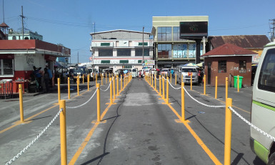 The barriers demarcating the queues at the routes 46, 41 and 45 bus park, in front of the Stabroek Market, Georgetown.  