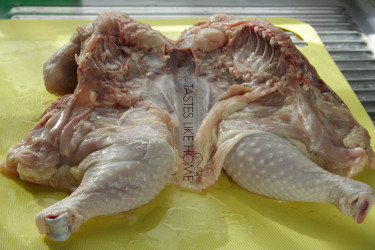 Pry the chicken apart and press down hard to break the breast bone so that the chicken lies flat (Photo by Cynthia Nelson) 