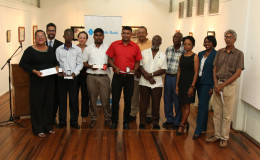 Artists along with the representatives of the Castellani House Management Committee,  Republic Bank and the Department of Culture at Castellani House yesterday, where the results of the Tenth Biennial National Drawing Competition were announced. Standing from left are artist Josefa Tamayo, who received the bronze medal for “Cannonball Flowers,” and artist Kwesi Archer, who received the silver medal for his entry, “The Yellow Girl.” The gold medal winner, Walter Gobin, was not present. (Keno George photo)