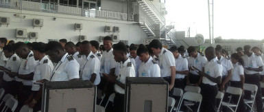 A section of the graduating class reciting the Mechanics Creed at their graduation at the Wings Aviation Ltd hangar, Ogle 