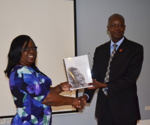 Minister in the Ministry of Public Health Dr Karen Cummings receiving a copy of the strategy from Dr Martin Odiit, UNAIDS Country Coordinator (GINA photo) 