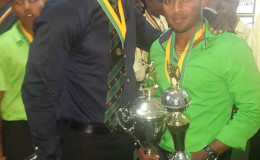 Guyana Jaguars Left-arm spinner Veerasammy Permaul strikes a pose with the team’s Assistant Coach Rayon Griffith last evening. Permaul copped the Guyana Cricket Board (2015) Male Cricketer of the Year award as well as the Rohan Kanhai Trophy for the Senior Regional Cricketer of the Year 2015.
