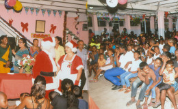  Composite photo shows Santa and Mrs Claus, patrons, volunteers and some of the children