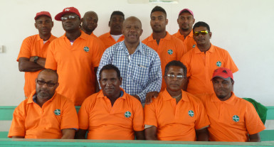 Moleson Creek bus drivers pose in their new uniforms with Director General of the Ministry of Tourism Donald Sinclair