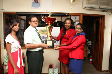 KMTC’s Cecil Kennard, receiving Metro’s sponsorship package from officials of the company yesterday.   