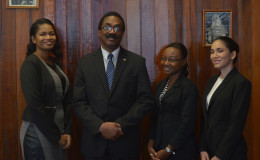 Attorney General Basil Williams poses with from left: 2013/2014 best student Narissa Leander, 2011/2012 best student Thandiwe Benn and 2014/2015 best student Eleanor Luckhoo
