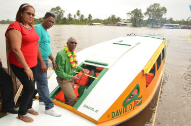 President David Granger commissioning the ‘David G’ V, yesterday, as Kumar Lallbachan, who donated the boat, and his wife Hardai Lallbachan look on. (Ministry of the Presidency photo)
