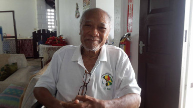 Compton Young at home. One of his Christmas floral arrangements is in the background.  