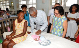 President David Granger meeting Christmas baby Tatianna, as First Lady Sandra Granger, Minister Amna Ally, Staff Nurse Michelle Holder and the baby’s mother, Venetia James look on. (Ministry of the Presidency Photo) 