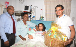 Camanie Kishon, gave birth to her first baby, a boy at Woodlands Hospital on Christmas Day. From left are ANSA Representative Joel Lee, nurse Omodelle Samuels and ANSA Representative Leon Fitzpatrick.