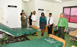 Savitri Chandrabose, Staff Nurse at the Leonora Diagnostic Centre (left) gestures while speaking to President David Granger (fourth from right), as Minister of Public Health, Dr George Norton (right)  and other officials listen during a guided tour of the old maternity wing of the hospital.  (Ministry of the Presidency photo)