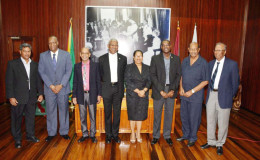 President David Granger (fourth from left) is flanked by, from left Commissioner Badrie Persaud; Minister of State, Joseph Harmon; new commissioners Rajendra Bissessar and Dela Atta Kuma Britton; Minister of Public Infrastructure, David Patterson; Chairman of the PUC, Retired Justice Prem Persaud; and  Commissioner Maurice Solomon.  
 
