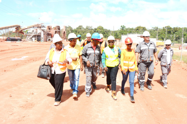 Minister Simona Broomes and BCGI workers on a walkabout at the Berbice River site
