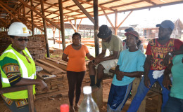 Simona Broomes with workers at Demerara Timbers