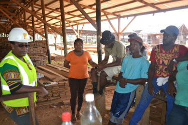 Simona Broomes with workers at Demerara Timbers