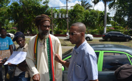 Human rights activist Mark Benschop (right) talking with President of the Rastafari Council of Guyana Ras Simeon (left)
