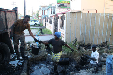 Workers clearing an alley as part of the city’s clean-up campaign. (Photo by Keno George) 
