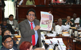 Look, it’s here! PPP/C MP Anil Nandlall holding up a copy of yesterday’s Stabroek News to make a point in Parliament yesterday. (Keno George photo)
