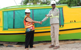 Minister of Social Cohesion, Amna Ally,shakes hands with Kenrick Glasgow, Logistics Manager at the Guyana Goldfields Inc/Aurora Gold Project (GINA photo)
