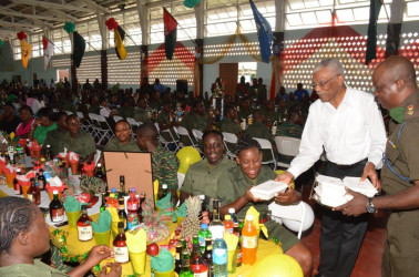 President David Granger (second from right) serving lunch at Base Camp Ayanganna yesterday. (Ministry of the Presidency photo) 