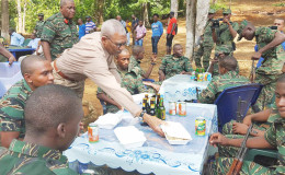 As per  custom, the Commander in Chief of the Armed Forces, President David Granger served ranks of the Guyana Defence Force today at their Christmas lunch. President Granger is pictured here performing the honours.  No styrofoam was used in the serving of this lunch. (Ministry of the Presidency photo)