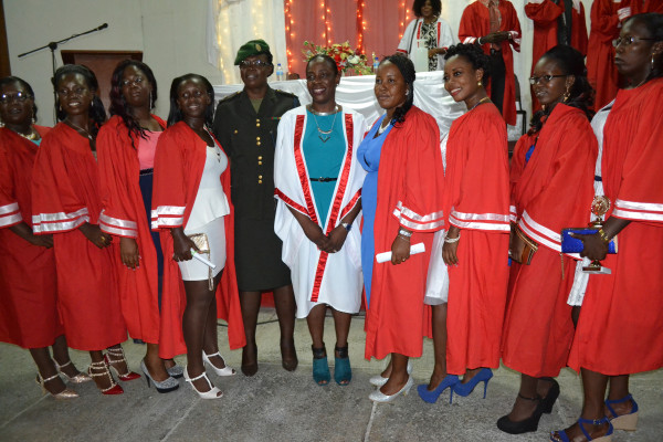 Minister within the Ministry of Education, Nicolette Henry (sixth from left) with some of the graduates. (Department of Culture, Youth and Sport photo)