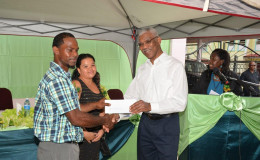 President David Granger (right) presents Ruella Waldron and Robert Gittens with their approval letter for a loan to expand their business.  The occasion was the launching yesterday of the Linden Enterprise Network’s (LEN)  micro credit programme at the newly refurbished Region 10 Business Centre. (Ministry of the Presidency photo)