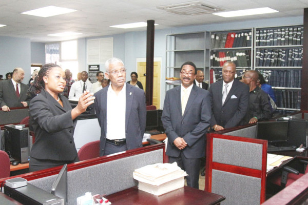 Registrar of Commerce (ag) Nicole Prince (left) shows President David Granger some of the documents located in the Commercial Registry. Looking on are Attorney General Basil Williams (third from left) and Minister of State Joseph Harmon (fourth left). The Commercial Registry is located above the Land Registry in the former New Building Society (NBS) building on the Avenue of the Republic. (Keno George photo)