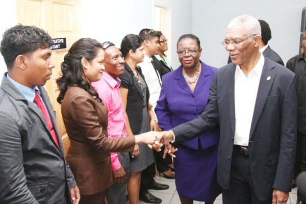 Registrar of Lands Rosalie Robertson (second right) took President David Granger on a tour of the Land Registry moments after the building was commissioned. In this Keno George photo President Granger meets with staff members of the registry.