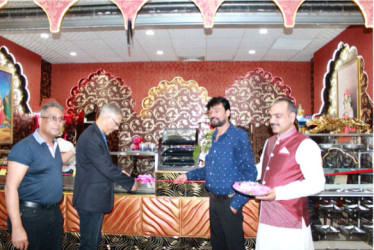 (From left)  Roy Beepat, President of Giftland; Minister of Business,  Dominic Gaskin; Proprietor of Taste of India, Hemant Banga and the Manager of the restaurant at the official opening.