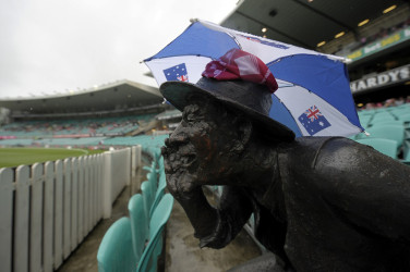 Even the Yabba statue it appears sought shelter from the rain which washed out the third day’s play between the West Indies and Australia at the Sydney Cricket Ground yesterday. (Cricinfo photo)