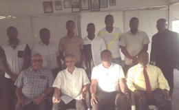 Minister of Business, Dominic Gaskin, (second from left sitting) is flanked by DCC President Alfred Mentore and others during the brief ceremony Sunday for the three national cricketers from the club.
