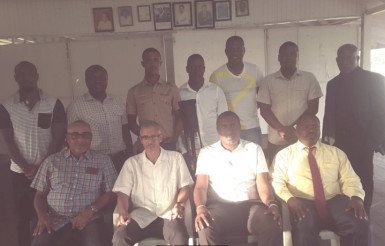 Minister of Business, Dominic Gaskin, (second from left sitting) is flanked by DCC President Alfred Mentore and others during the brief ceremony Sunday for the three national cricketers from the club.