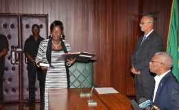 Valerie Adams-Patterson taking the Oath of Office in the presence of President David Granger at the Ministry of the Presidency. (Ministry of the Presidency photo)
