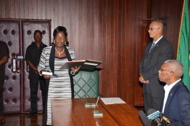 Valerie Adams-Patterson taking the Oath of Office in the presence of President David Granger at the Ministry of the Presidency. (Ministry of the Presidency photo) 