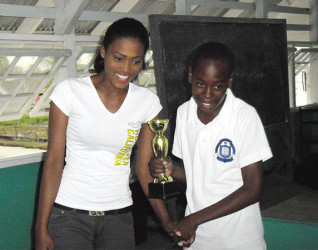 In the individual category of the Berbice Schools competition, Darwin London of the Berbice Educational Institute placed first. In photo, an elated Darwin receives his winning trophy from Malesha Mackoon. 