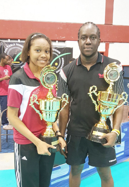 Chelsea Edghill, left and Christopher Franklin with the coveted trophies after the won the women and men’s singles titles at the Guyana Table Tennis Association (GTTA) national championships yesterday at the National Gymnasium. (Orlando Charles photo) See page 27