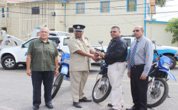 The handing over of the keys to the motor cycles by Advance Security Corporate Secretary, Mohamed Ally (second from right) to Assistant Commissioner (Administration) Balram Persaud as other officials looked on.
