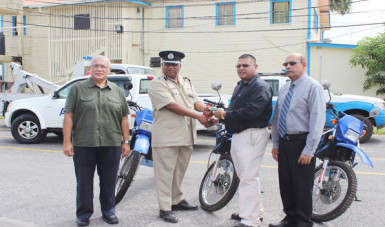 The handing over of the keys to the motor cycles by Advance Security Corporate Secretary, Mohamed Ally (second from right) to Assistant Commissioner (Administration) Balram Persaud as other officials looked on. 
