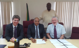 Minister of Natural Resources, Raphael Trotman (centre) flanked by British High Commissioner to Guyana Greg Quinn and John McKenna of Tullow Oil. (Ministry of the Presidency photo)
 