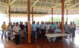 Leaders of the 20 North Rupununi Communities witnessing the signing of the agreements by Dane Gobin, CEO of Iwokrama Centre (seated left) and Anthony Andries, Chairman of the North Rupununi District Development Board (seated right) at the Iwokrama River Lodge at Kurupukari (Iwokrama photo)