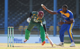 Carlos Brathwaite attempts to run out Delorn Johnson during the second semi-final between Windward Islands Volcanoes and Barbados Pride in the NAGICO Super50 Tournament yesterday at Queen’s Park Oval. Photo by WICB Media/Ashley Allen
