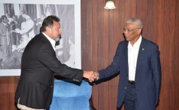 President David Granger (right) shakes hands with Director of the Princess International Group, Mehmet Hamdi Karagozoglu at the Ministry of the Presidency (GINA photo)
