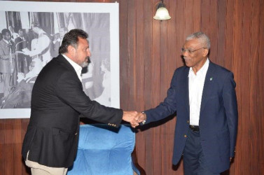 President David Granger (right) shakes hands with Director of the Princess International Group, Mehmet Hamdi Karagozoglu at the Ministry of the Presidency (GINA photo) 