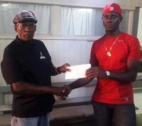 Coach of the Flying Ace Cycle Club and event organizer, Randolph Roberts (left) receives the sponsorship package from CEO of the Benjamin’s Sports Store, Wilbert Benjamin.