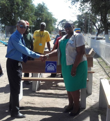 GNSC’s Project Manager Eion Oudkerk presenting the benches to Assistant Town Clerk Sherry Jerricks at the Merriman Mall play park. 