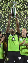 West Indies star Andre Russell holds the Big Bash title aloft after Sydney Thunder captured the men’s final yesterday.